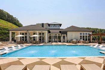 A large house with a pool in front.